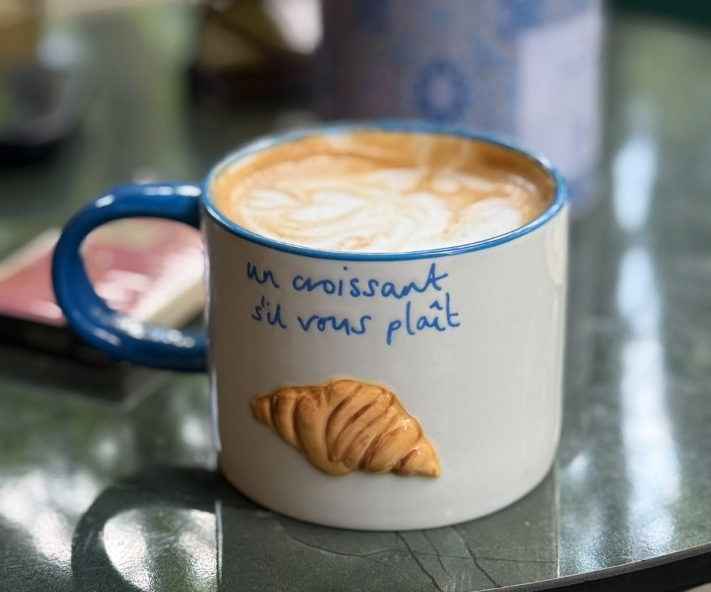Breakfast at E'lane — coffee, pastry and a set table