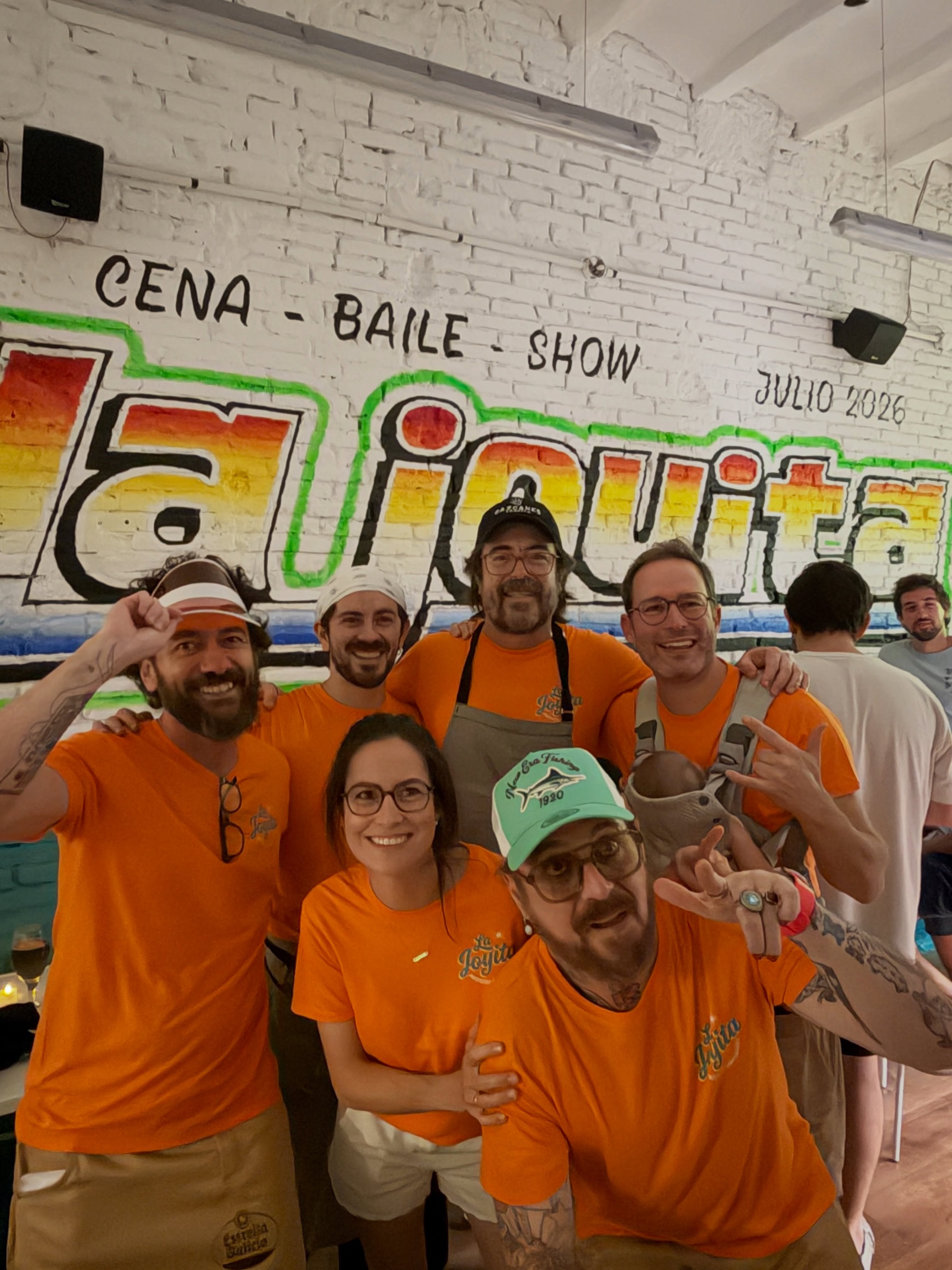 The team in the dining room at La Joyita, mural dated July 2026