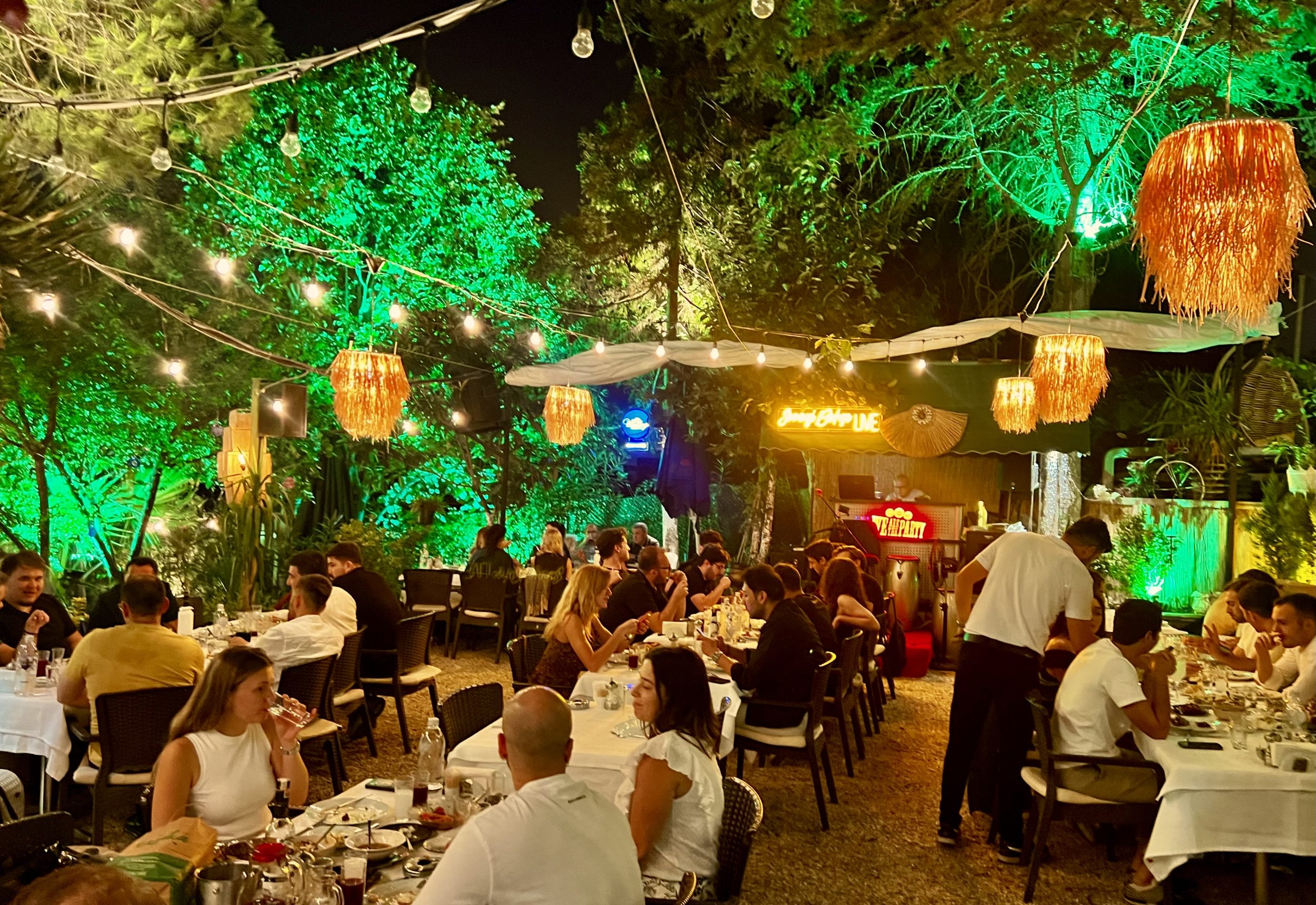 The dining room at Sanayi Bahçe, brick, plants and hanging lamps